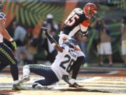 Cincinnati Bengals tight end Tyler Eifert (85) scores a touchdown against Seattle Seahawks cornerback Cary Williams (26) in the second half of an NFL football game, Sunday, Oct. 11, 2015, in Cincinnati.