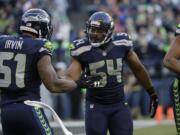 Seattle Seahawks middle linebacker Bobby Wagner (54) and outside linebacker Bruce Irvin (51) react to a play against the San Francisco 49ers in the second half Sunday, Dec. 14, 2014, in Seattle.