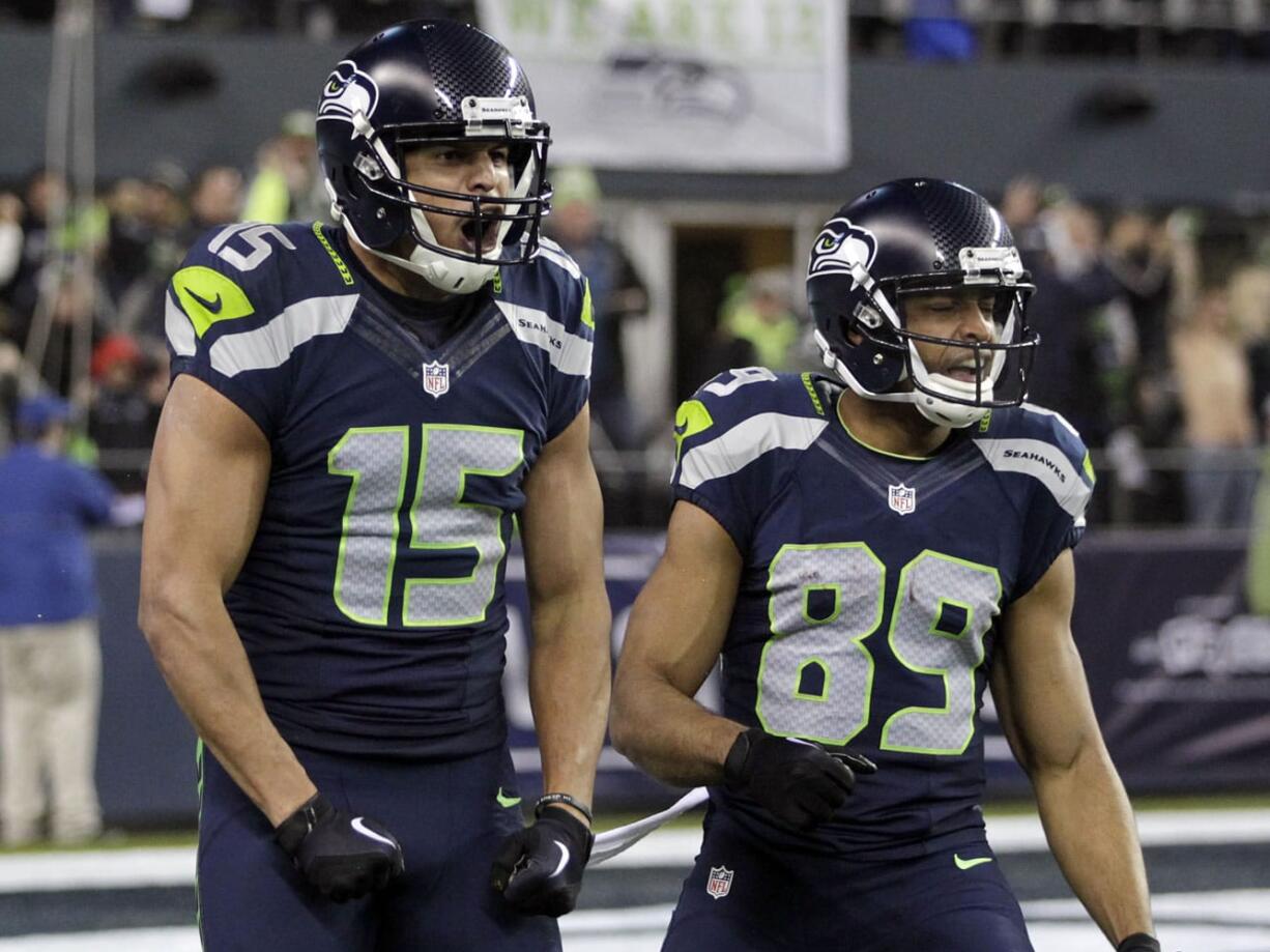 Seattle Seahawks wide receiver Jermaine Kearse (15) celebrates after scoring on a 63-yard touchdown reception next to wide receiver Doug Baldwin (89) during the first half of an NFL divisional playoff football game against the Carolina Panthers in Seattle, Saturday, Jan. 10, 2015.