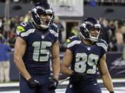 Seattle Seahawks wide receiver Jermaine Kearse (15) celebrates after scoring on a 63-yard touchdown reception next to wide receiver Doug Baldwin (89) during the first half of an NFL divisional playoff football game against the Carolina Panthers in Seattle, Saturday, Jan. 10, 2015.