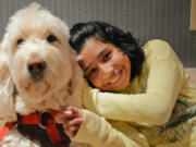 Ehlena Fry poses with her service dog, Wonder, at their home in Manchester, Mich., on Friday. The U.S. Supreme Court is being asked to take an appeal from Ehlena Fry, with cerebral palsy who switched schools after her service dog wasn't welcomed in a district in Jackson County.