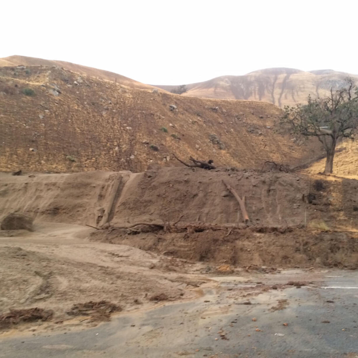 Debris sits along Interstate 5 at Fort Tejon, about 75 miles north of downtown Los Angeles, on Thursday. Flash flooding sent water, mud and rocks rushing across the interstate, stranding hundreds of vehicles and closing the major north-south thoroughfare.