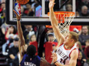 Phoenix Suns guard Brandon Knight (3) hits a shot over Portland Trail Blazers forward Mason Plumlee (24) during the fourth quarter of an NBA basketball game against the Portland Trail Blazers in Portland, Ore., Saturday, Oct. 31, 2015. The Suns won the game 101-90.