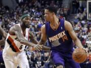 Phoenix Suns forward Gerald Green, right, dribbles against Portland Trail Blazers guard Will Barton during the first half of an NBA basketball game in Portland, Ore., Friday, April 4, 2014.