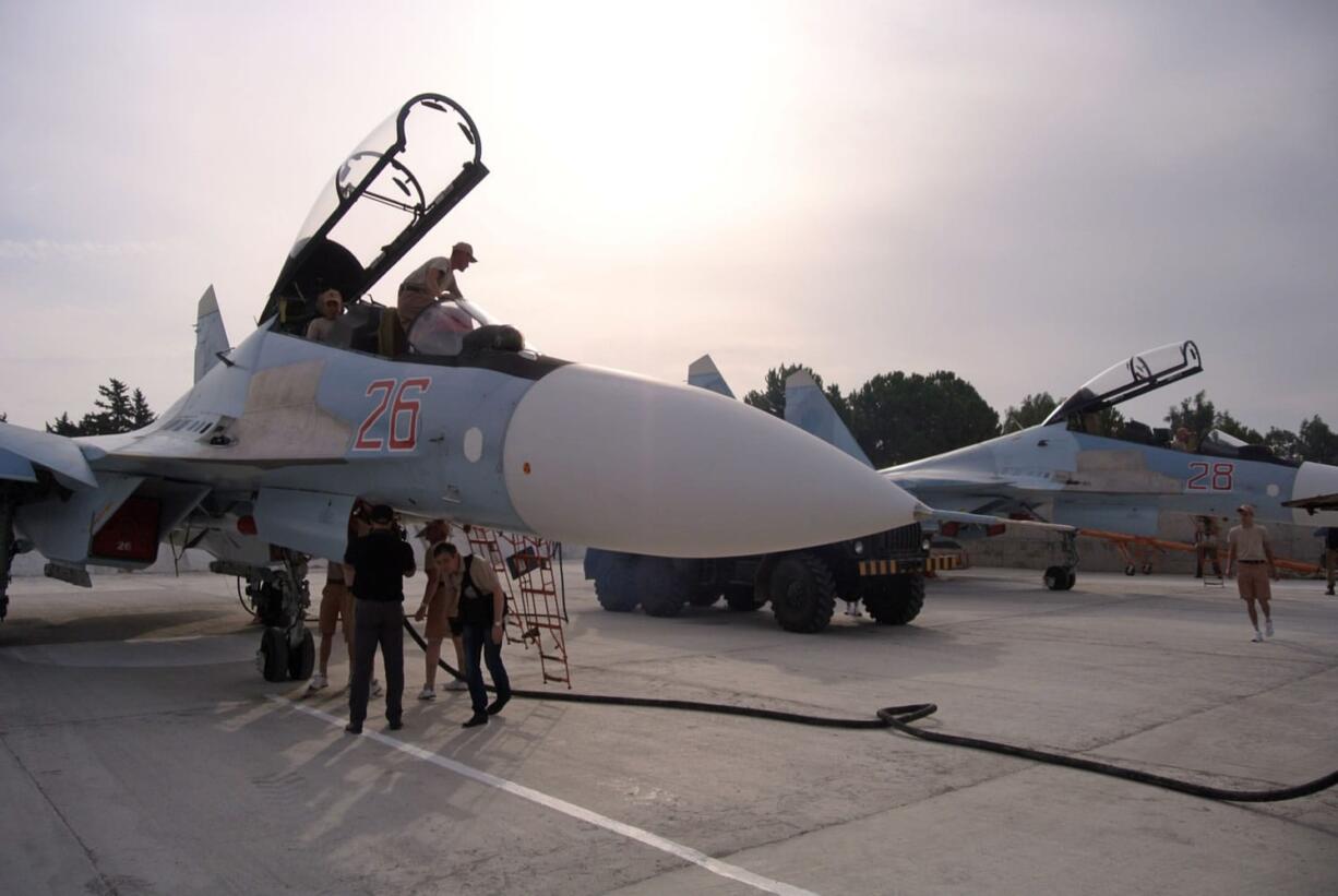 Ground crew prepare fighter jets for combat sorties at Hemeimeem airbase, Syria, on Thursday. Since early morning, Russian combat jets have been taking off from this base in western Syria, heading for missions.