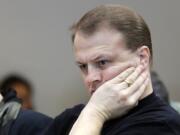 Initiative promoter Tim Eyman waits for his turn to speak before the Senate Ways and Means Committee on Feb. 9 at the state Capitol in Olympia.