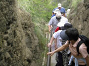 Visitors to Diamond Head tackle the steep 1.6-mile, round-trip trail Feb. 18, 2010, up to the summit on Oahu in Hawaii. Diamond Head, a volcanic crater located at one end of Waikiki on the coast of Oahu, is one of Hawaii&#039;s most famous landmarks as well as one of its most popular tourist attractions.