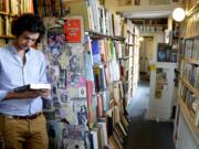 Marco P. Cremasco, 28, of Sao Paulo, Brazil, browses through Downtown Books, located on the iconic Route 66 in Albuquerque, N.M. Route 66 is home to a number of bookstores, often attracting regulars from around the corner and visitors from around the world.