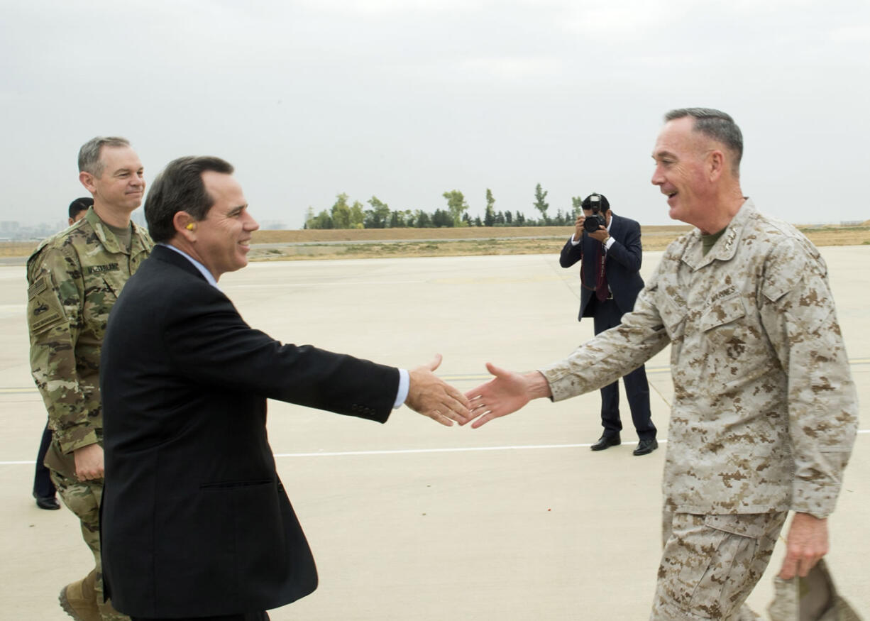 U.S. Ambassador to Iraq, Stuart E. Jones and U.S. Army Lt. Gen. Sean McFarland, left, greet Joint Chiefs Chairman Gen. Joseph Dunford Jr. upon his arrival at Erbil, Iraq, on Tuesday. Dunford landed in Iraq Tuesday to get an update on the battle against Islamic State militants, saying he sees no prospect right now for Russia to expand its airstrike campaign into the war-torn country. (D.