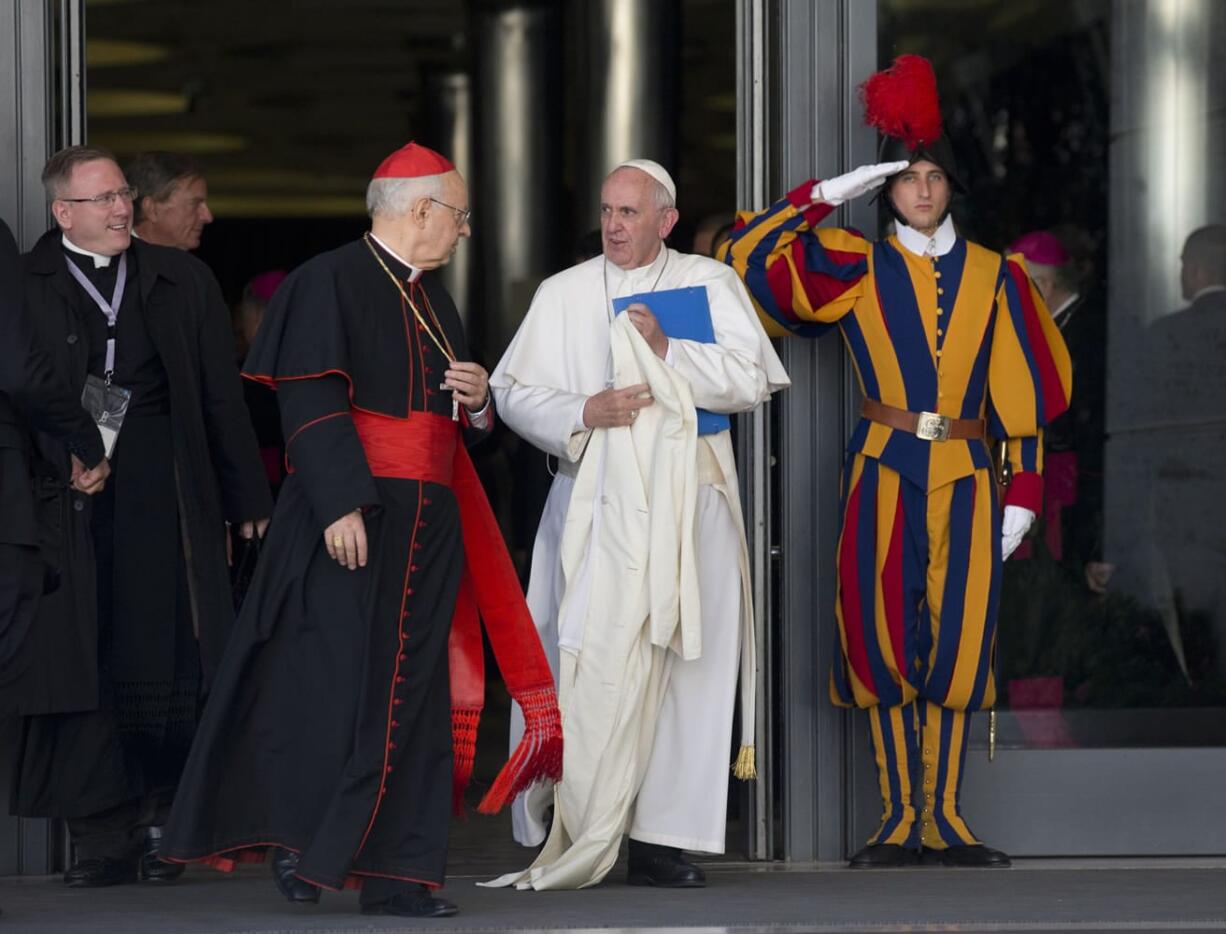 Pope Francis talks to Cardinal Lorenzo Baldisseri as he leaves at the end of a morning session of the Synod of bishops at the Vatican on Friday.