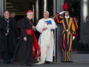 Pope Francis talks to Cardinal Lorenzo Baldisseri as he leaves at the end of a morning session of the Synod of bishops at the Vatican on Friday.