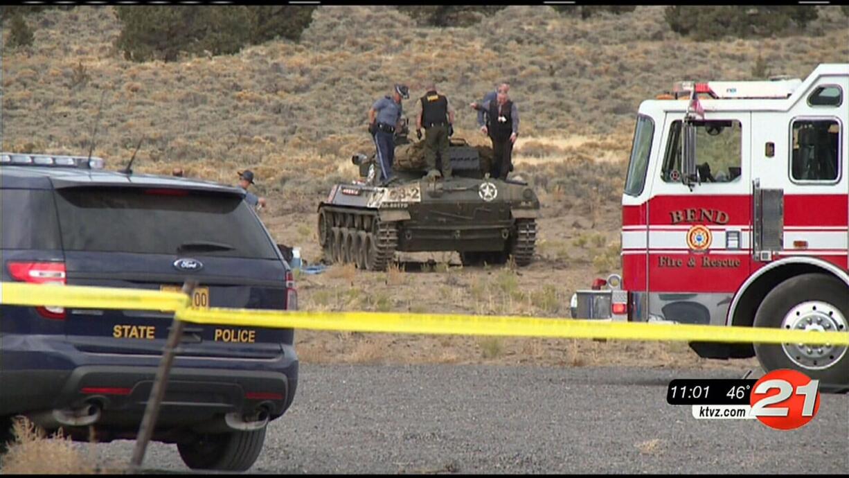 Investigators inspect the scene of an explosion inside a World War II-era tank at a public firing range that left two people dead near Bend, Ore.