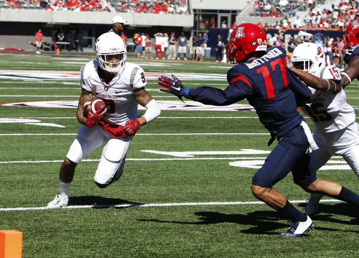 Washington State wide receiver Gabe Marks, left, scores a touchdown in front of Arizona cornerback Jace Whittaker (17) during the first half of an NCAA college football game, Saturday, Oct. 24, 2015, in Tucson, Ariz.