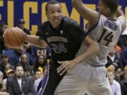 Washington center Robert Upshaw (24) drives against California forward Christian Behrens (14) during the first half in Berkeley, Calif., Friday, Jan. 2, 2015.