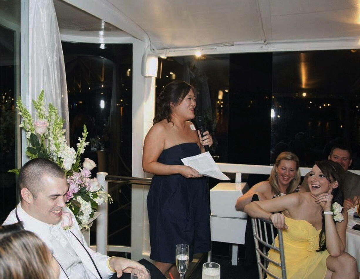 Jennifer Paik, center, delivers the maid of honor toast at the wedding of best friend Joo Cha in Newport Beach, Calif.  Stories made the speech memorable, she said.