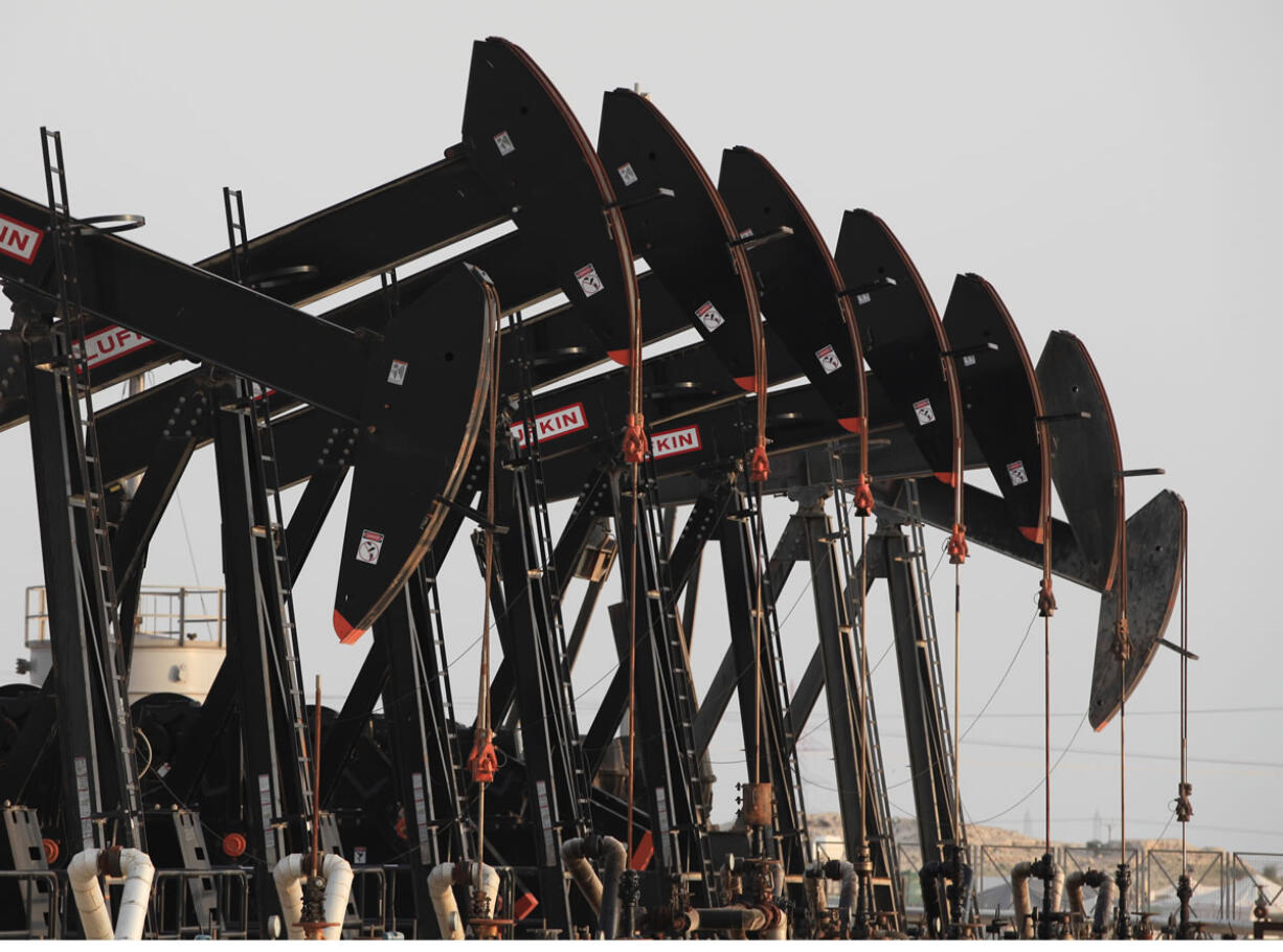 Oil pumps work in the Persian Gulf desert oil field of Sakhir, Bahrain. In the second half of 2014, oil prices dropped by half, to depths not seen since May of 2009 when the U.S.