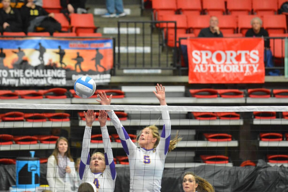 Columbia River's Lindsay Marshall, left, and Esti Wilson look to block a shot against Prairie during the 3A state volleyball tournament Friday in  Kennewick.