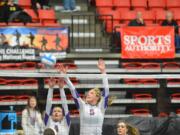 Columbia River's Lindsay Marshall, left, and Esti Wilson look to block a shot against Prairie during the 3A state volleyball tournament Friday in  Kennewick.