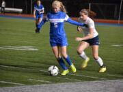 Ridgefield midfielder Kelly Casper dribbles past an Ellensburg defender in the 2A state girls soccer semifinals Friday in Shoreline. The Spudders won 5-1 and will play for their first state title against Squalicum at 4 p.m.