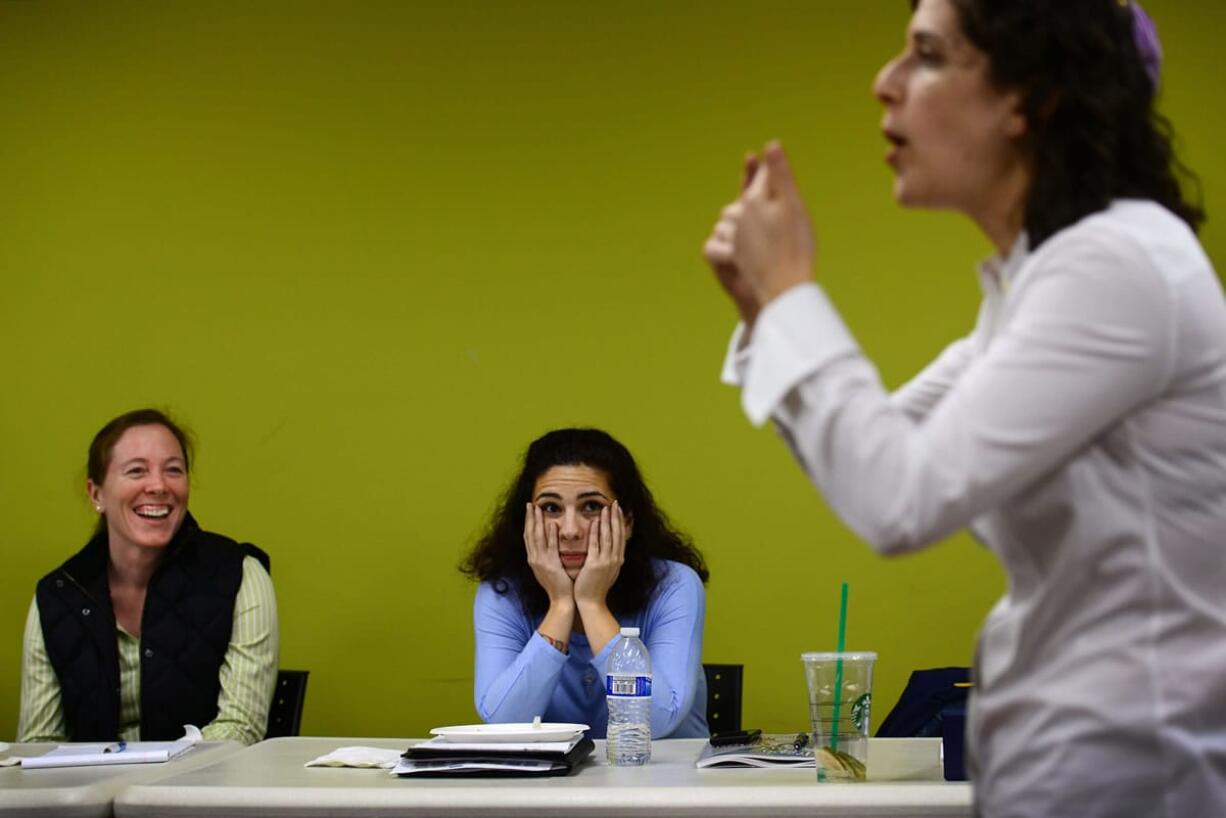 Allison Dougherty, left, and Irella Keehnle listen as Rabbi Shira Stutman discusses circumcision at a Dec.