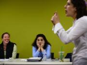 Allison Dougherty, left, and Irella Keehnle listen as Rabbi Shira Stutman discusses circumcision at a Dec.