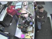 Investigators say this man distracted a gas station clerk at the deli counter while another man stole hundreds of dollars worth of lottery tickets.