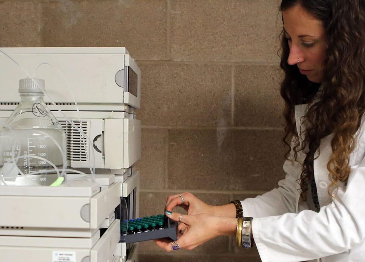 Microbiologist and lab supervisor Jaclyn Mauser tests the THC content of marijuana samples Jan.