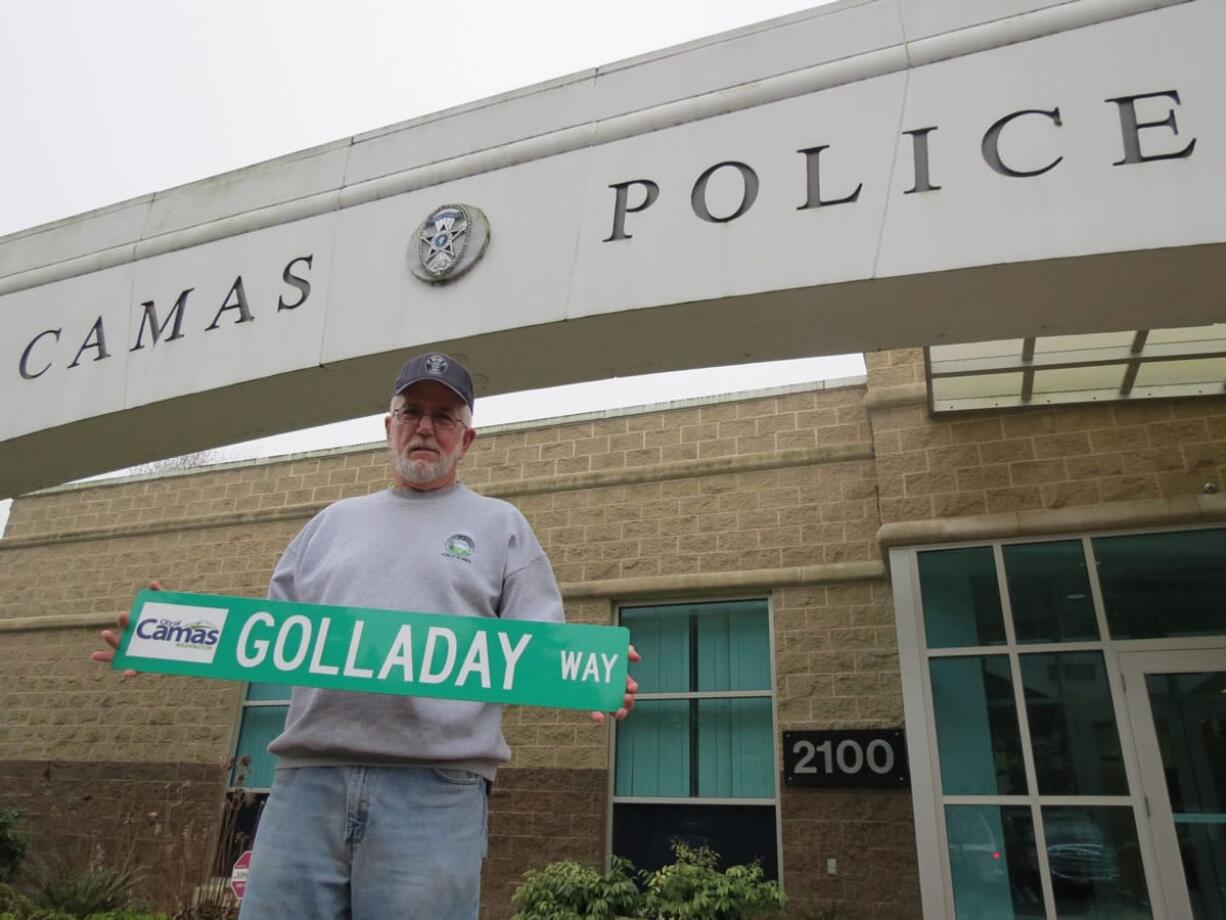 Dick Golladay holds a road sign given to him as a retirement gift from the Camas Police Department. He served his community as a Papermaker, firefighter, police officer and a landscaper.