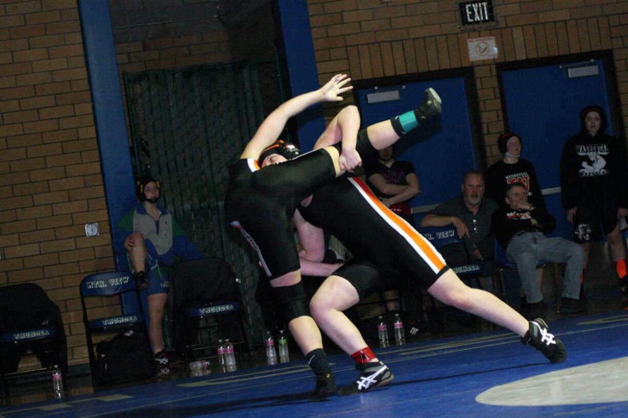 Erin Locke lifts Washougal teammate Morgan Ratcliff off the mat during the 130-pound Clark County championship match Saturday, at Mountain View High School in Vancouver.