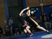 Erin Locke lifts Washougal teammate Morgan Ratcliff off the mat during the 130-pound Clark County championship match Saturday, at Mountain View High School in Vancouver.