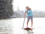 Travis Fuhrer takes a Sweetwood Paddleboard for a spin at Lacamas Lake. This is just a taste of the activities in store for the World Paddleboard Association's Salmon Classic Aug.