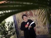 Genie Milgrom stands in the backyard of her Pinecrest home in front of a very special mosaic that she created. Milgrom, a Cuban woman who was raised Catholic, converted to Judaism after she began researching her maternal lineage.