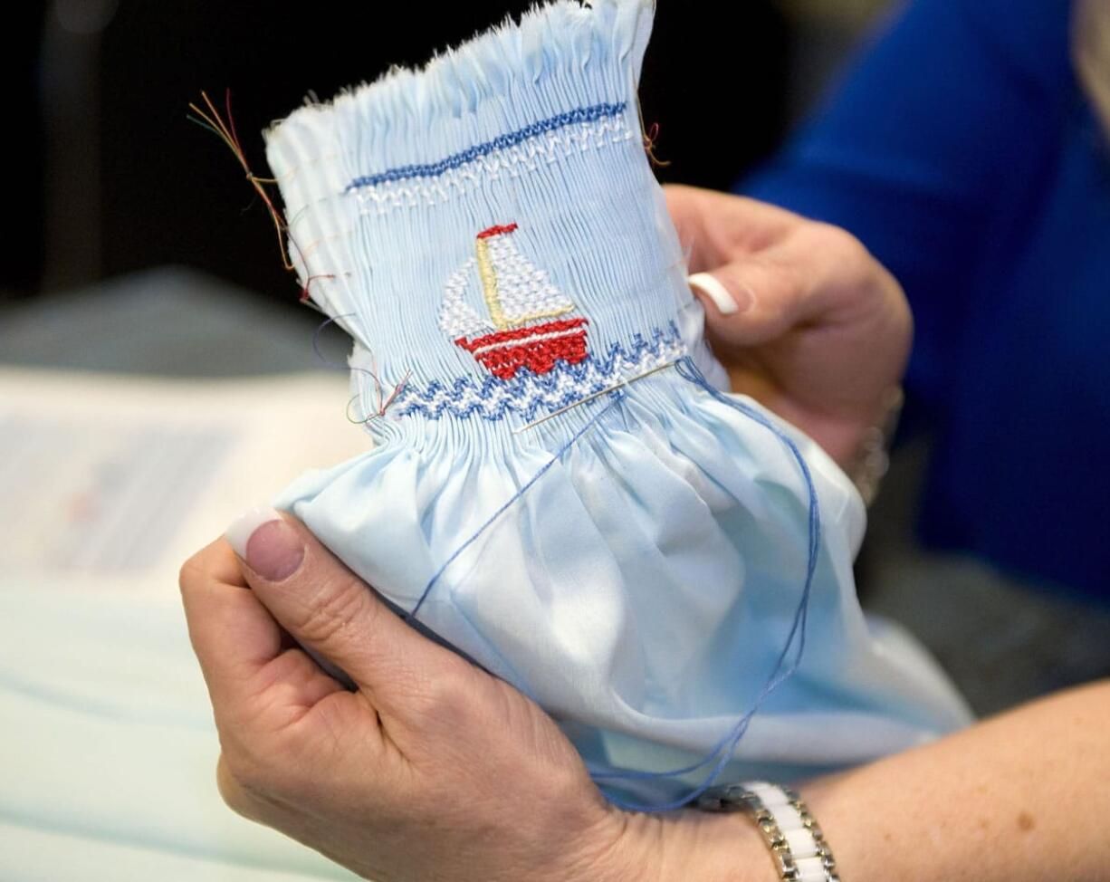 Becky Pierce shows some of her elaborate needlework.