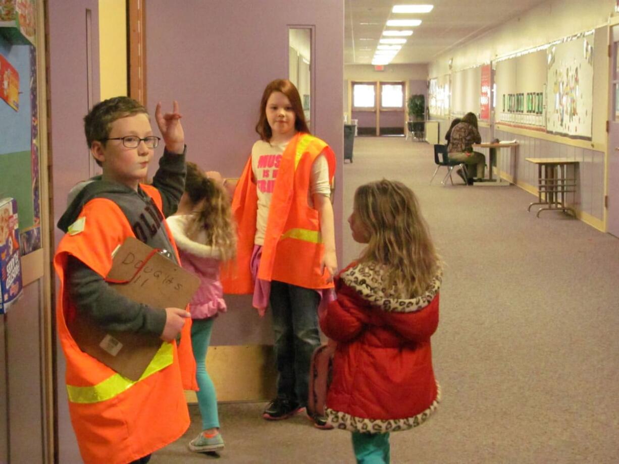 Fifth-graders Jaden Carstens (left) and Taylor Vincent are members of the Hathaway Elementary School Peacemakers program, designed to help decrease playground conflicts among younger students and promote positive behavior.