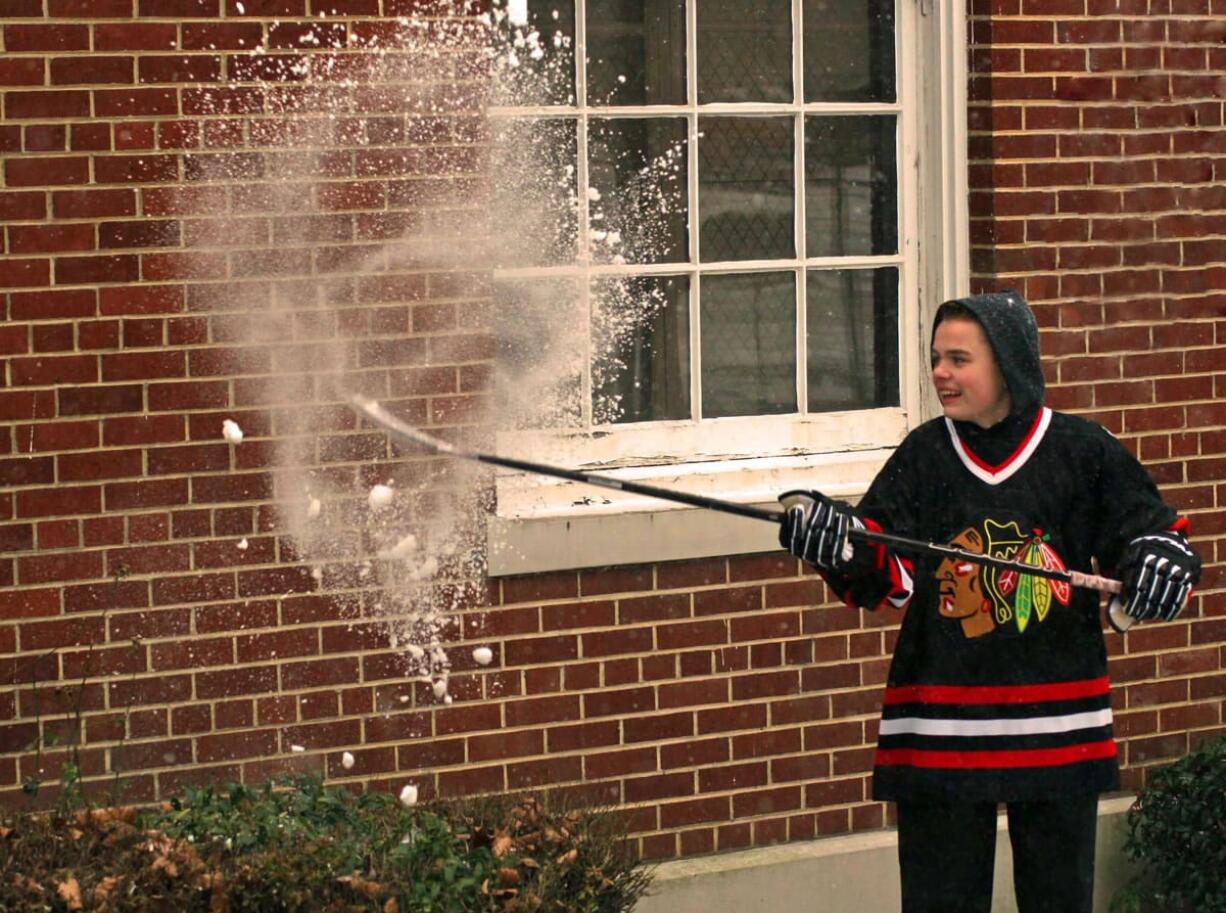 Ryan Stevens smashes a snowball with his hockey stick. The 14-year-old from Washougal plays for the Junior Winter Hawks.