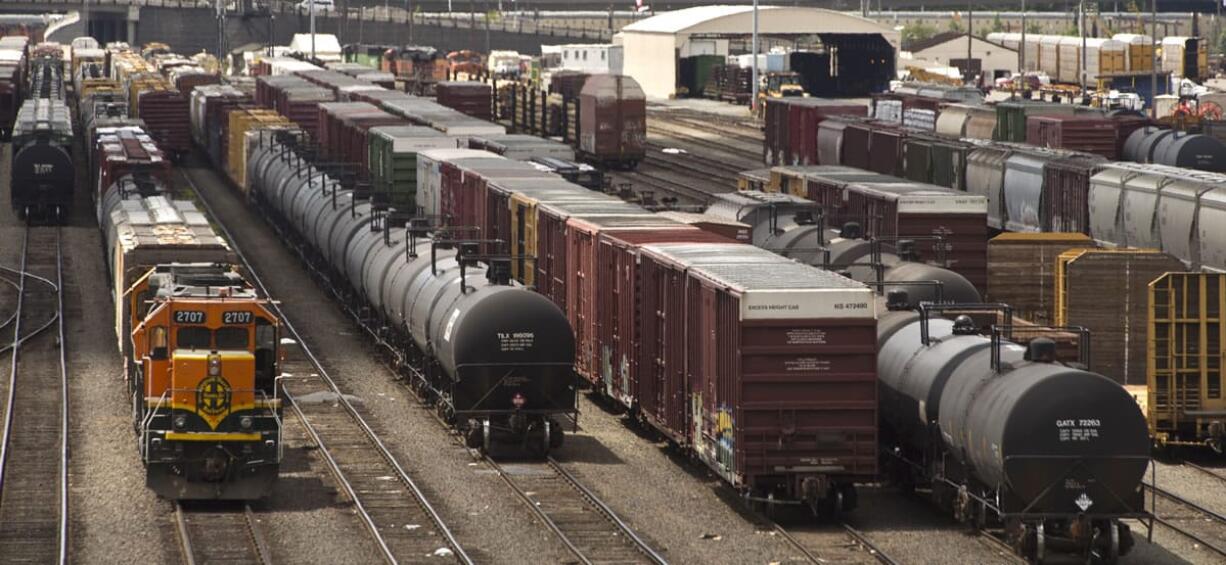 Files/Tacoma News Tribune
Black tanker cars used to transport crude oil from North Dakota are parked among other rail traffic at a train yard in Tacoma in June. Each car holds between 680 and 720 barrels of oil, according to BNSF Railway; a proposed Port of Vancouver terminal could handle up to 380,000 barrels -- more than 525 tanker cars -- a day.