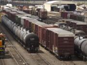 Files/Tacoma News Tribune
Black tanker cars used to transport crude oil from North Dakota are parked among other rail traffic at a train yard in Tacoma in June. Each car holds between 680 and 720 barrels of oil, according to BNSF Railway; a proposed Port of Vancouver terminal could handle up to 380,000 barrels -- more than 525 tanker cars -- a day.