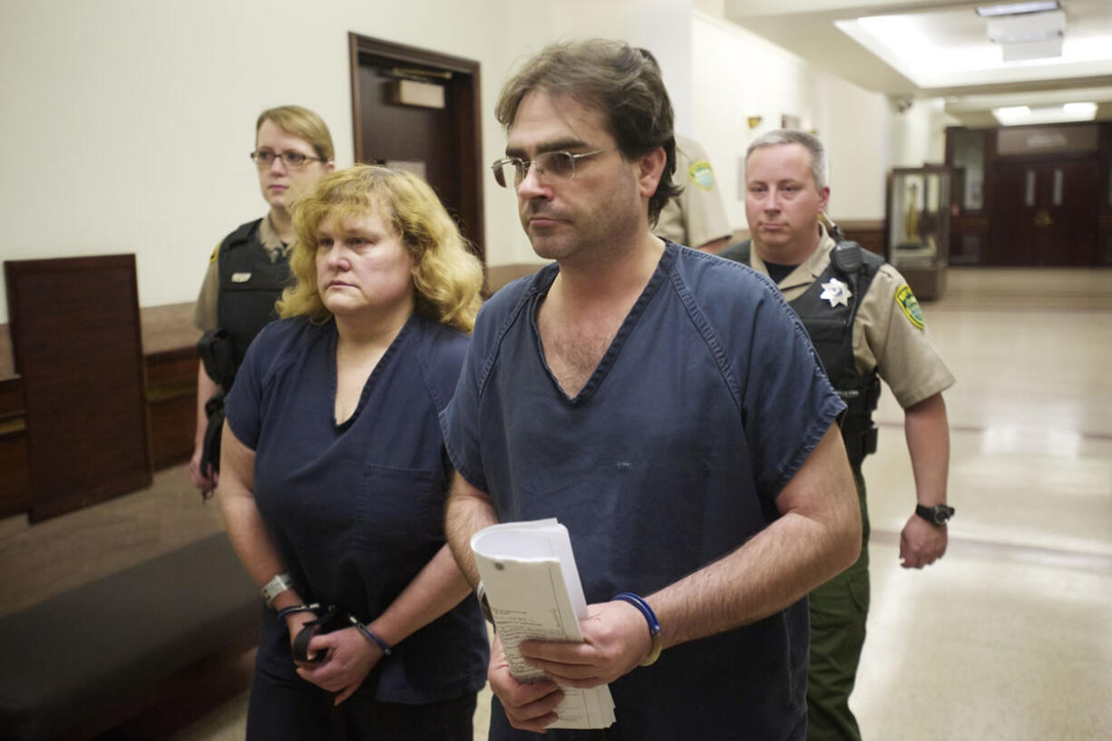 Sandra and Jeffrey Weller enter Judge Barbara Johnson's courtroom for sentencing in Clark County Superior Court March 20, 2013. The Wellers were convicted of imprisoning, starving and beating their adopted twins.