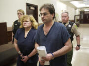 Sandra and Jeffrey Weller enter Judge Barbara Johnson's courtroom for sentencing in Clark County Superior Court March 20, 2013. The Wellers were convicted of imprisoning, starving and beating their adopted twins.