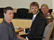 Alan Northrop, left, Innocence Project staff attorney John Pantazis and Larry Davis pose for a photograph July 14, 2010 before the beginning of a hearing set to officially dismiss  rape charges against the men on the basis of new DNA evidence.