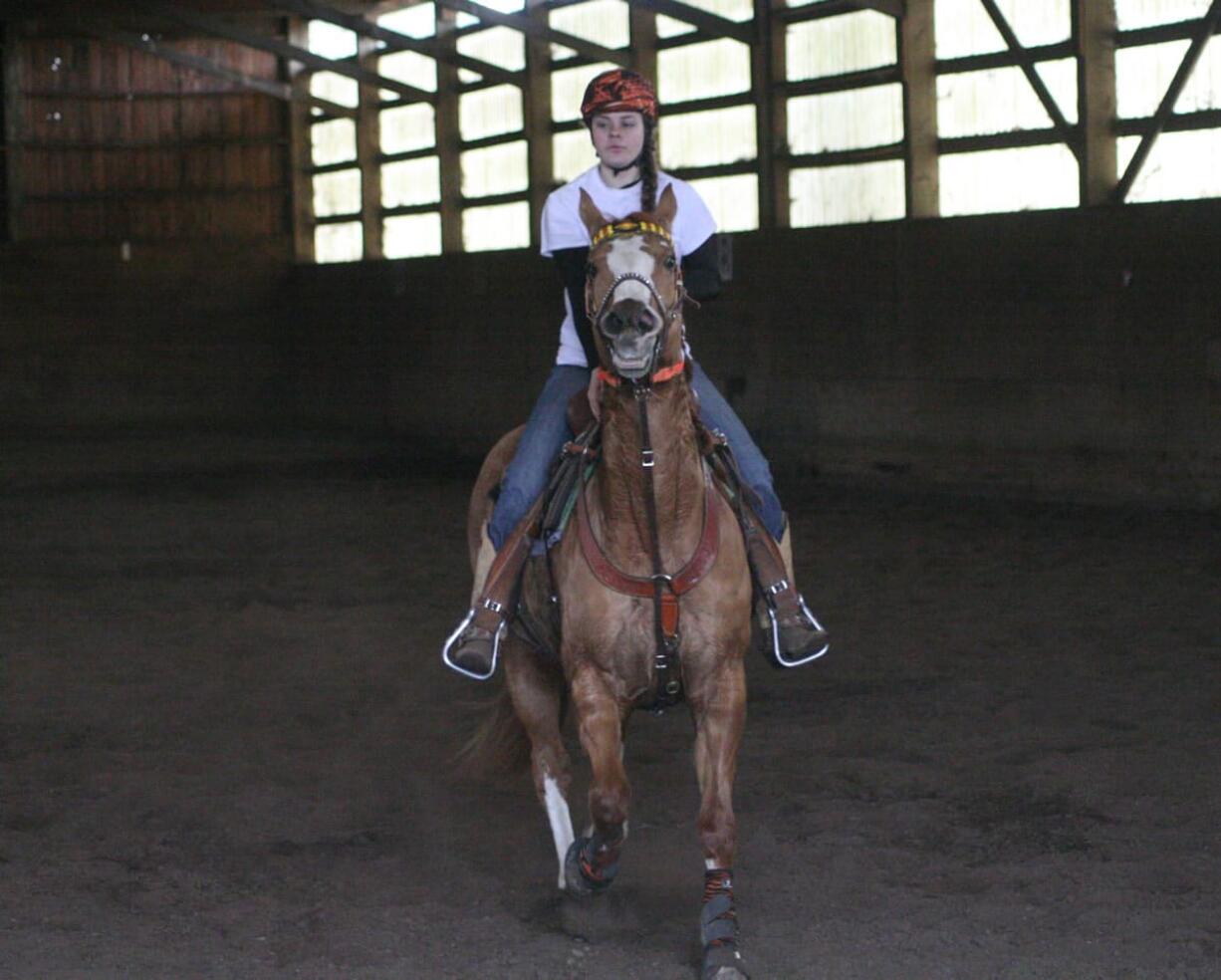 Washougal High School Equestrian Team President Fee Harrison and Hollie Mae show what they can do during practice at Windy Ridge, in Washougal. &quot;I'm her brain and her body, and she's my wings.