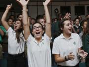 Gwen Bruderly, from left, Olivia Conti and Jordan Keathley, all freshmen at St. Vincent-St. Mary High School in Akron, Ohio, cheer as members of The Takeover, a ministry group with the nonprofit Generation Akron, presents a Hope Assemblies at the school in September.