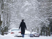 Dee Clingan walks along Northwest 43rd Street on an icy Sunday in Vancouver.