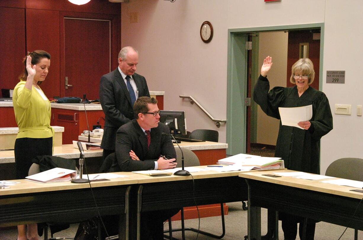 Clark County Superior Court Judge Barbara Johnson, right, swears in state Sen.