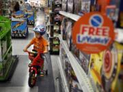 Nathan Pang, 3, test drives a bicycle around the Toys R Us store on Los Feliz Boulevard in Los Angeles.