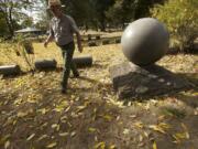 Fort Vancouver archaeologist Doug Wilson walks past grave markers in Vancouver's Old City Cemetery in 2012.