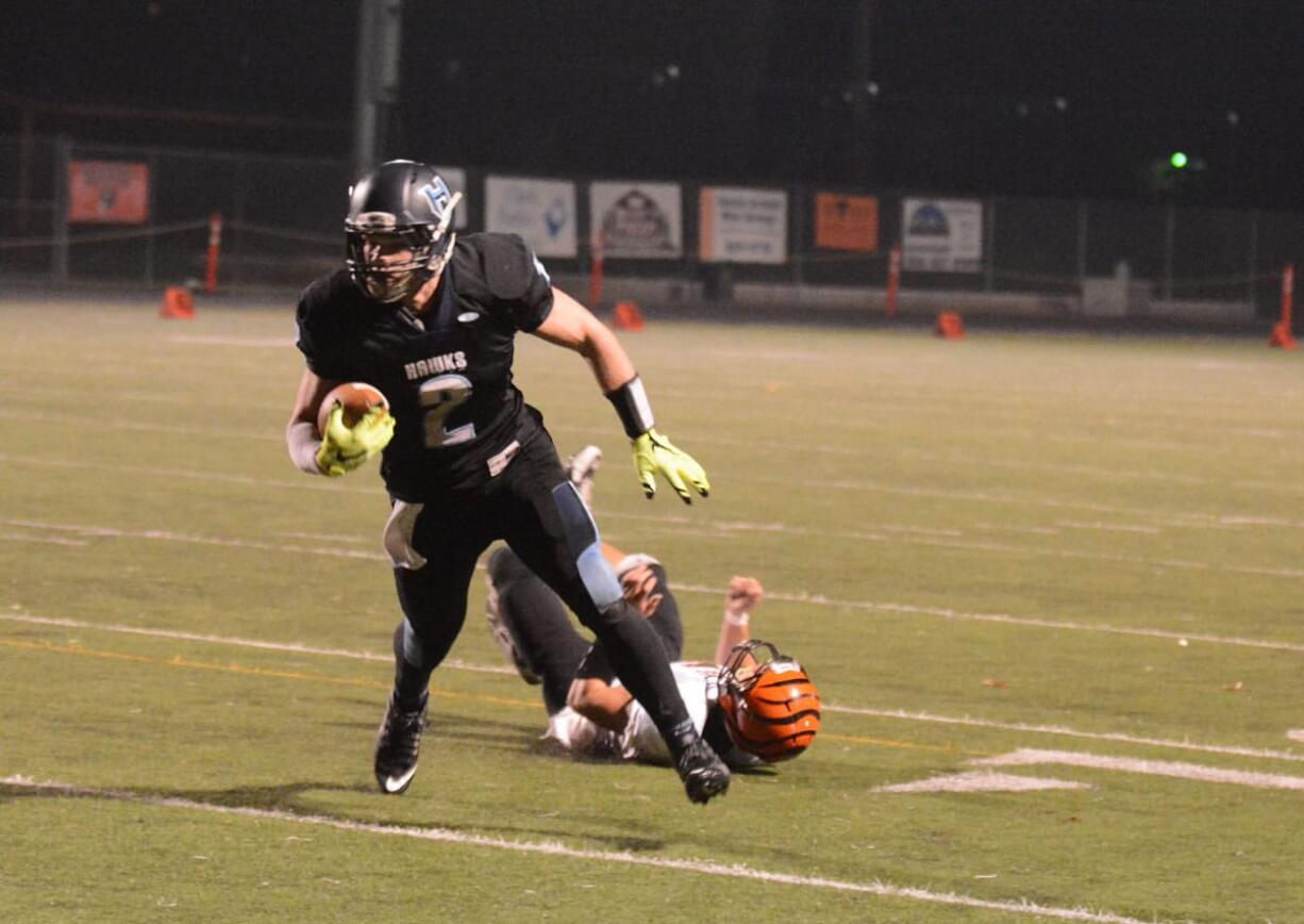 Hockinson tight end Cameron Loos breaks a tackle on his way to scoring a touchdown during the second quarter of Hockinson&#039;s 54-14 win Friday.