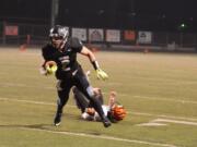 Hockinson tight end Cameron Loos breaks a tackle on his way to scoring a touchdown during the second quarter of Hockinson&#039;s 54-14 win Friday.