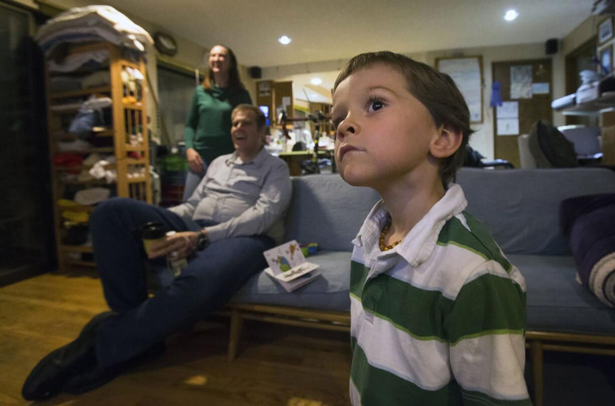 Gabriel Ruthford fixes his gaze on the television as he watches his favorite documentary about trains at his home in Maple Valley.