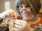 Allison Harper focuses on her needlework during a beading session at her Vancouver home this week.